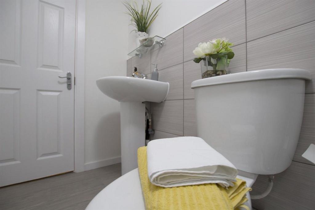 Bright, modern bathroom with clean white fixtur...