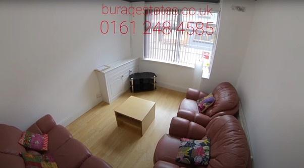 Bright, simply furnished living room with lamin...