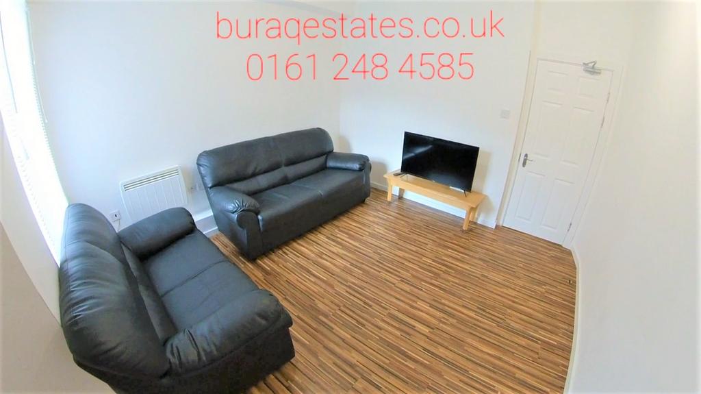 Bright, simply furnished living room with two c...