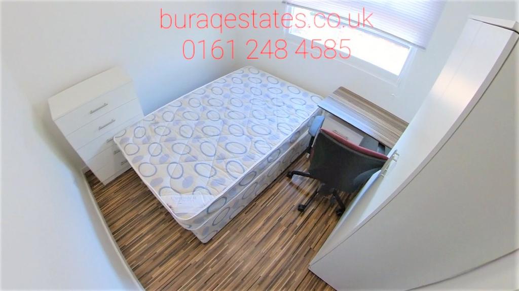 Bright, simply furnished bedroom with a comfort...