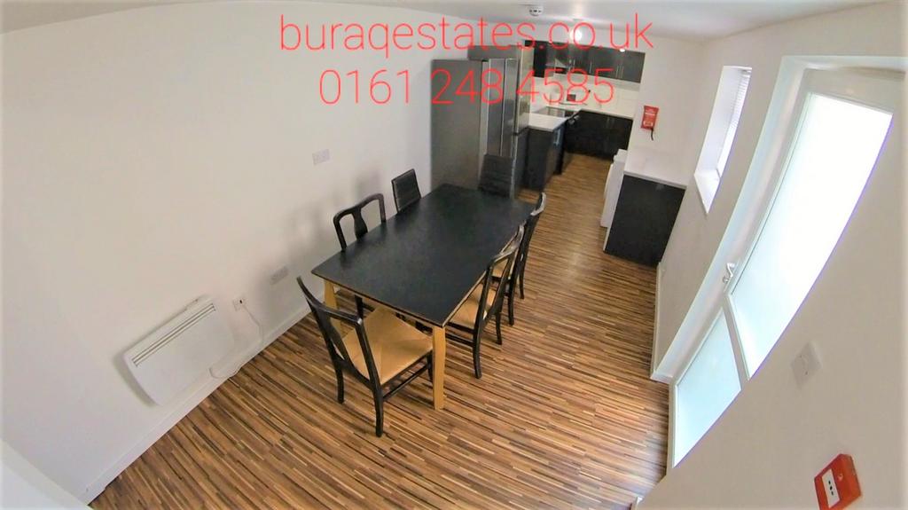 Bright communal dining and lounge area with a l...