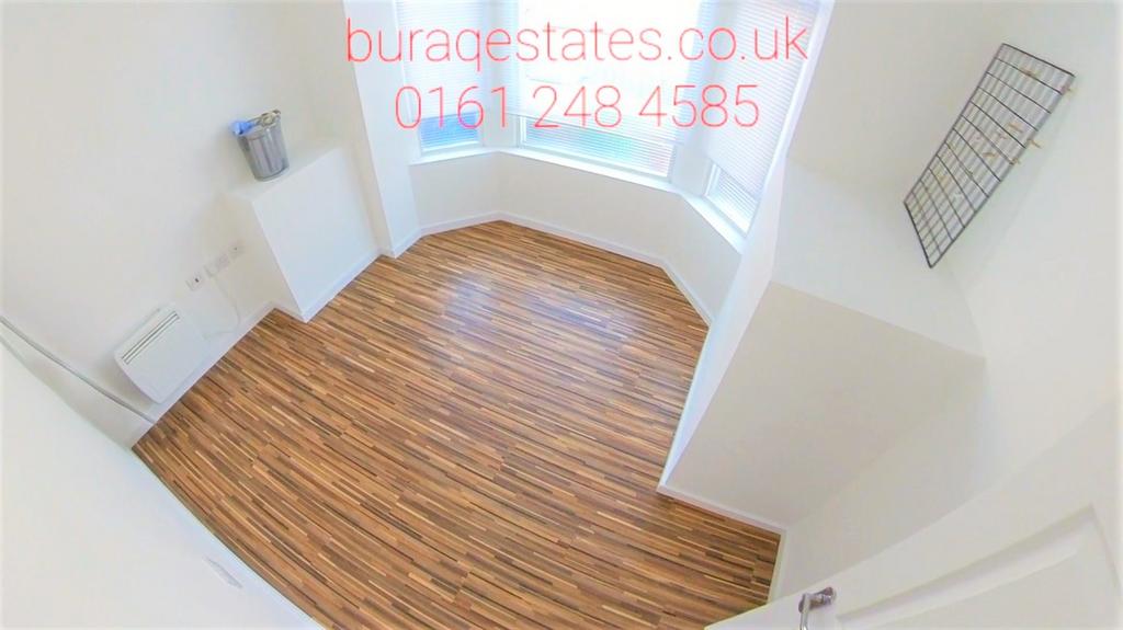 Bright, freshly painted bedroom with wood-effec...