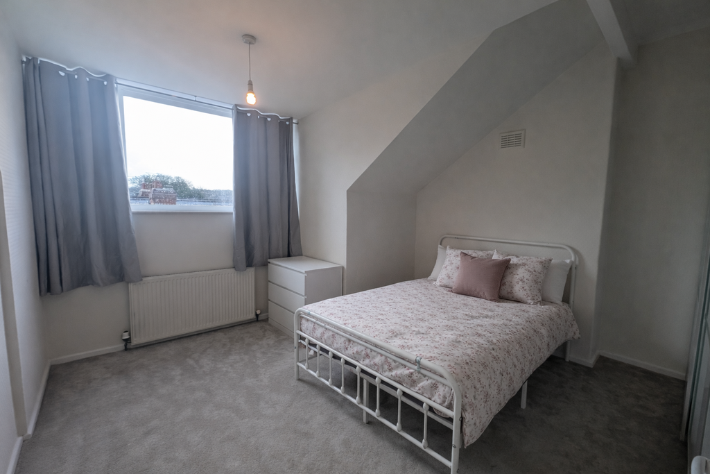 Cozy attic bedroom with floral accents