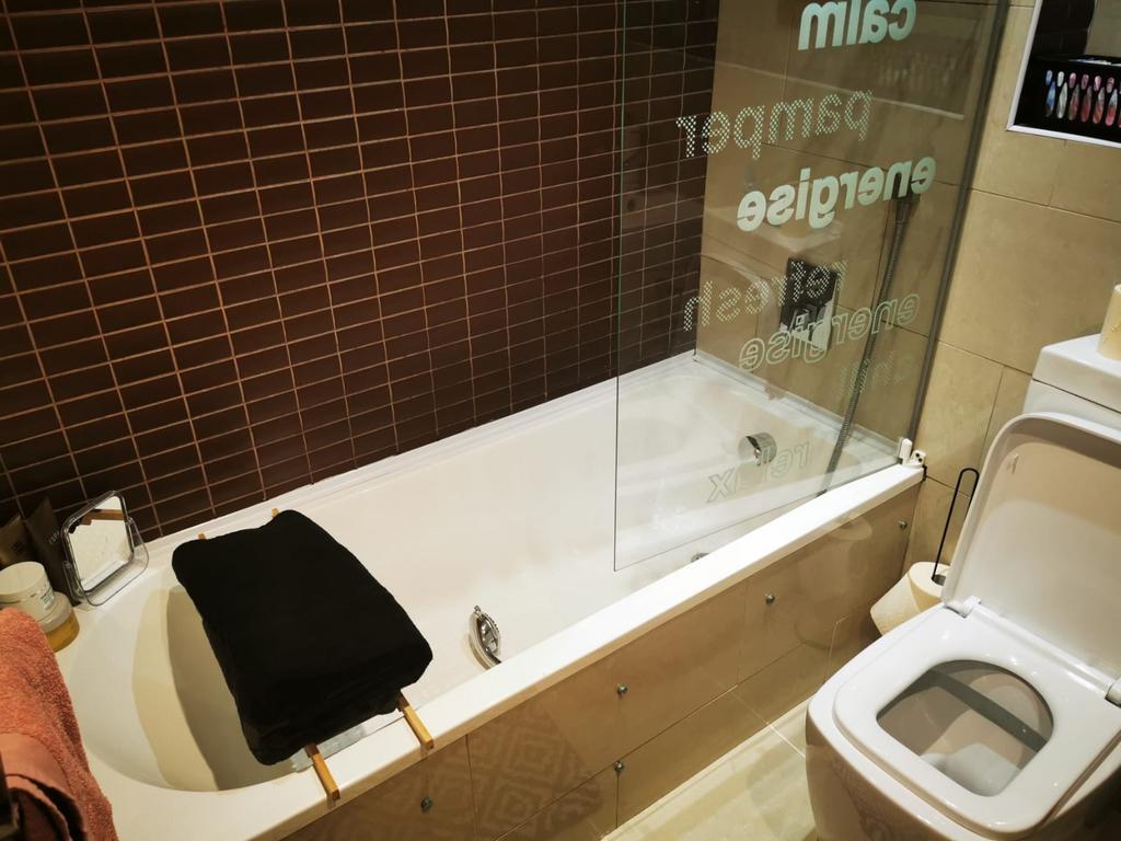 Modern bathroom suite with a built-in bathtub a...