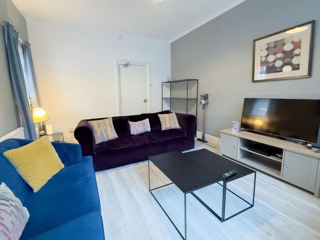 Bright, modern living room with two comfortable...