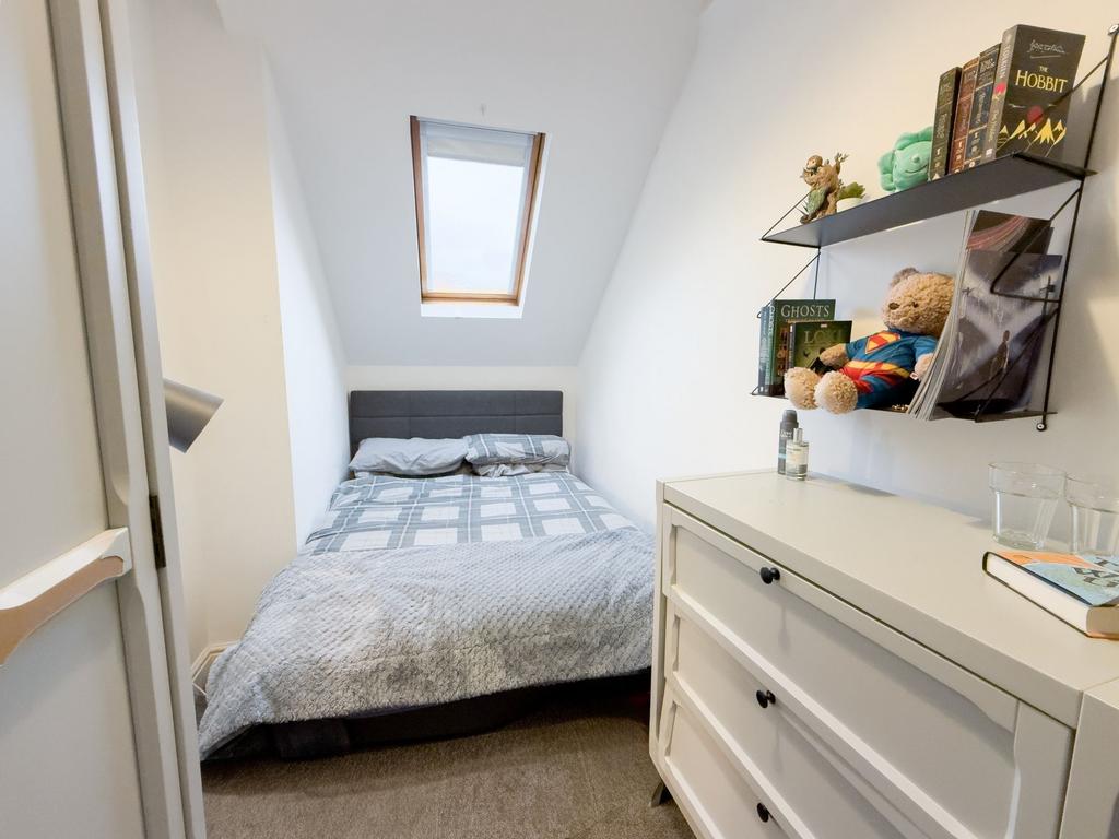 Bright, neatly presented bedroom with a cosy do...