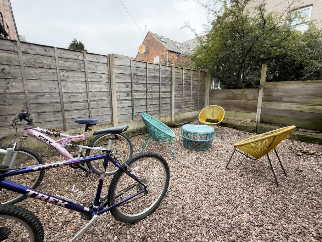 Private gravel courtyard with colourful outdoor...