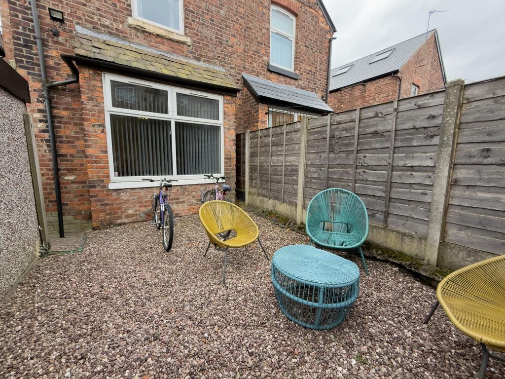 Private gravel courtyard with colourful outdoor...