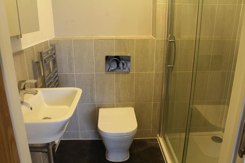 Modern tiled bathroom with a wall-hung toilet, ...