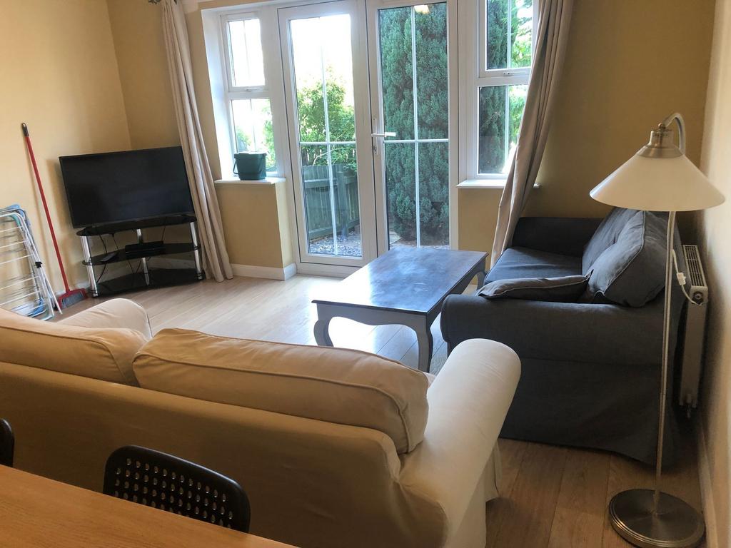 Bright, neatly presented living room with Frenc...