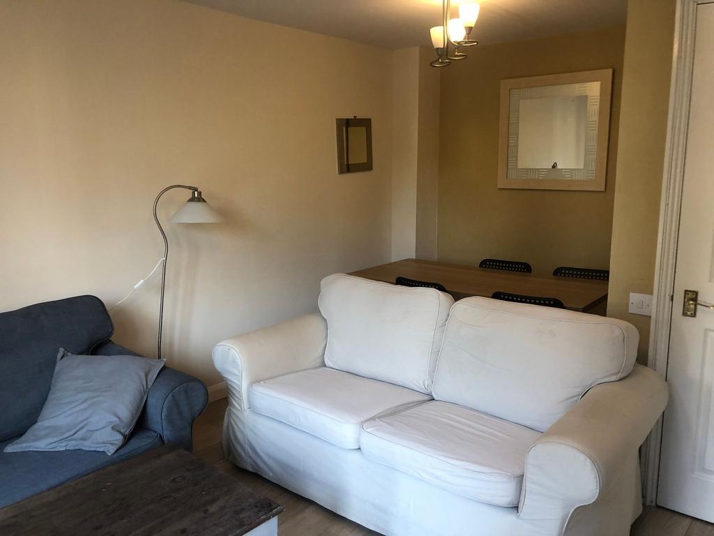 Bright, cozy living room with comfortable sofas...