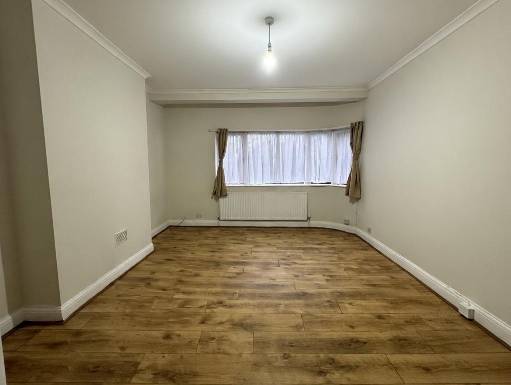 Bright, neutral living room with wood-effect fl...