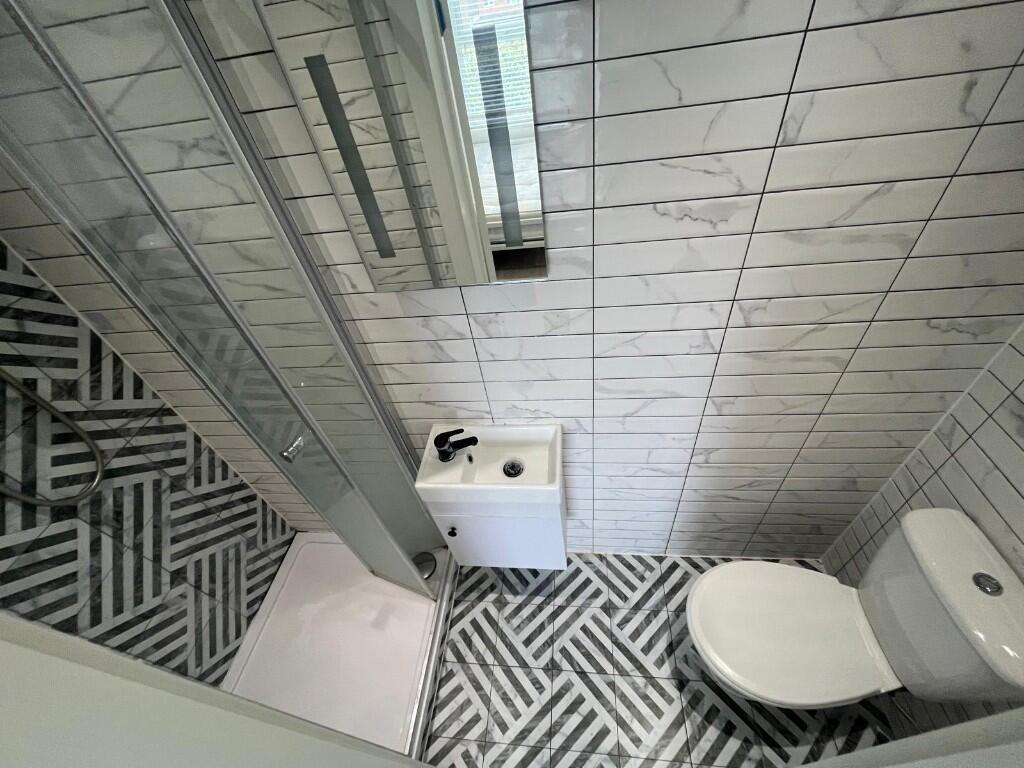 Contemporary tiled bathroom with patterned floo...