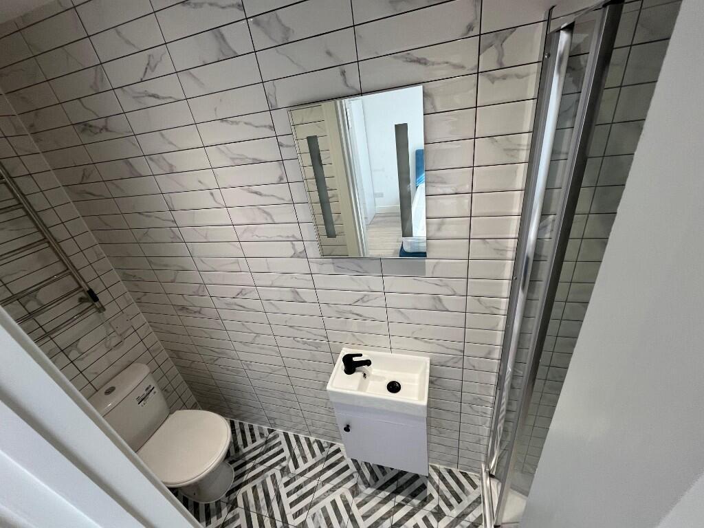 Modern tiled bathroom with patterned floor tile...