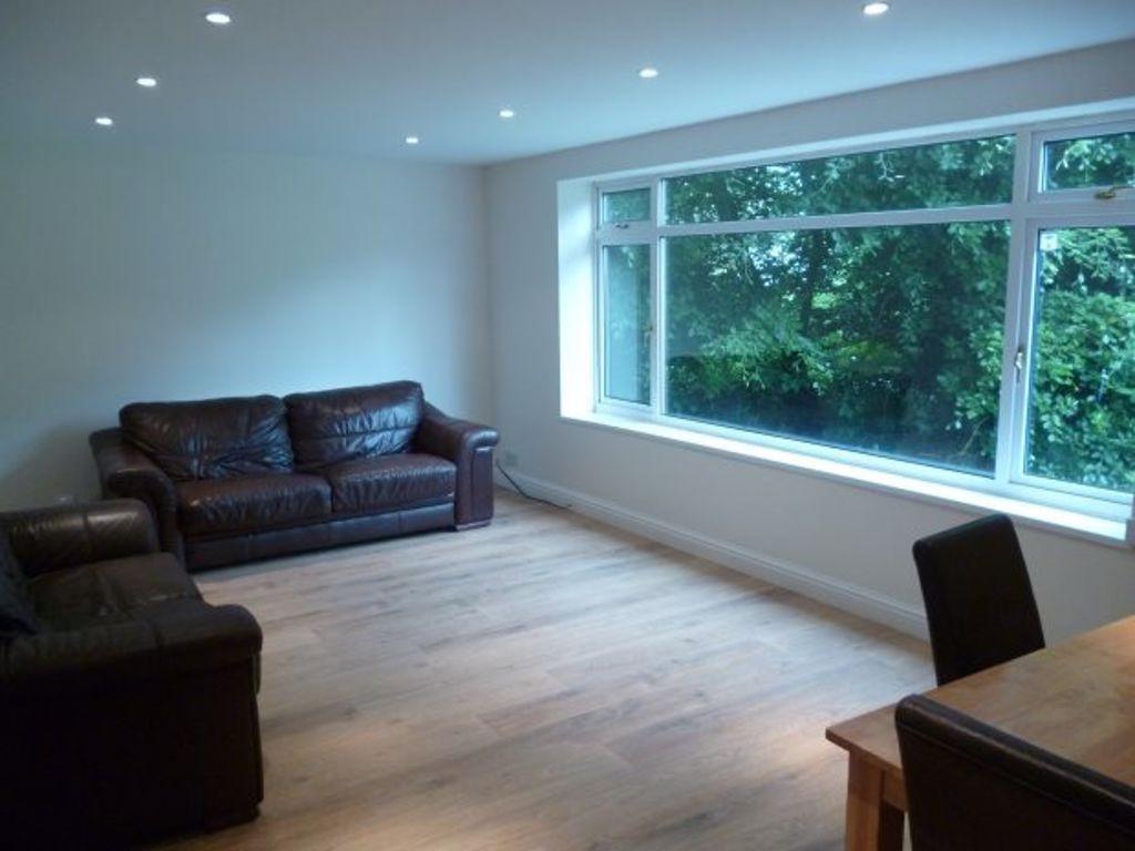 Bright, modern living room with wide picture wi...