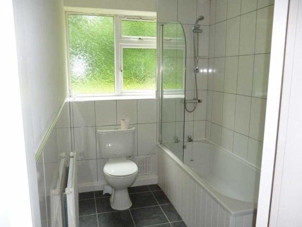 Bright, clean bathroom with a modern white suit...