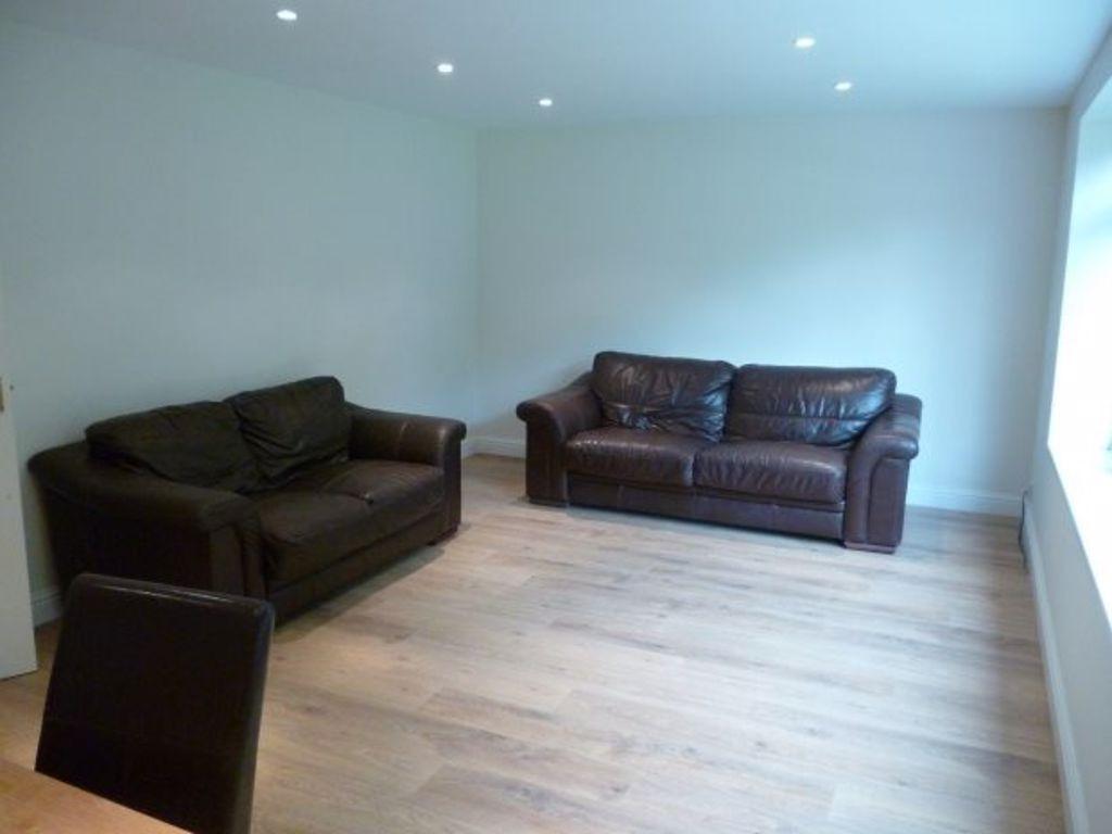 Bright, minimally furnished living room with li...