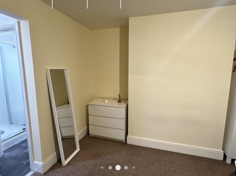 A simple and clean single bedroom featuring neu...