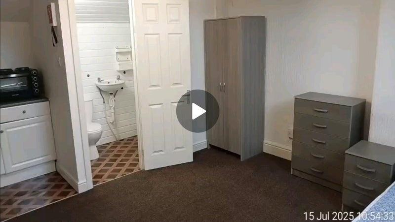 A neatly arranged double bedroom featuring a wa...