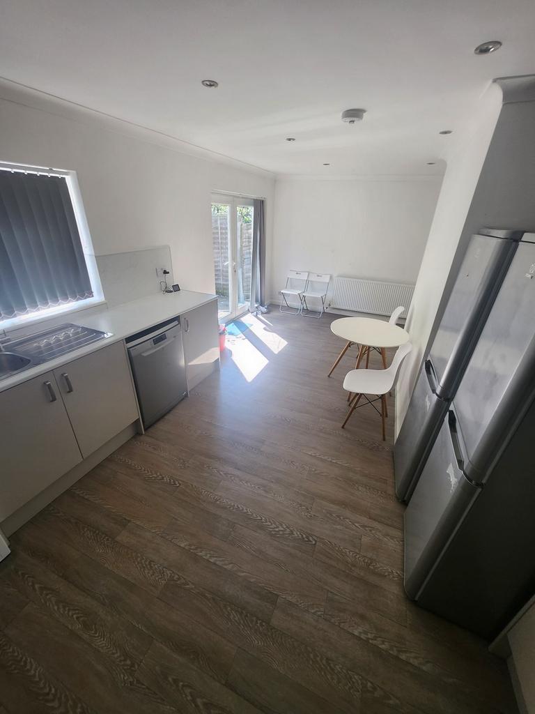 Bright, modern kitchen with white cabinets, int...