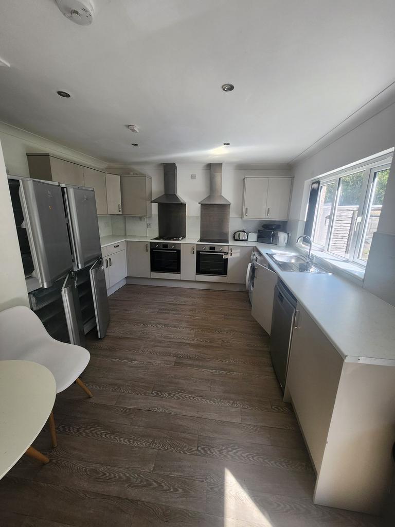 Bright modern kitchen with two stainless steel ...