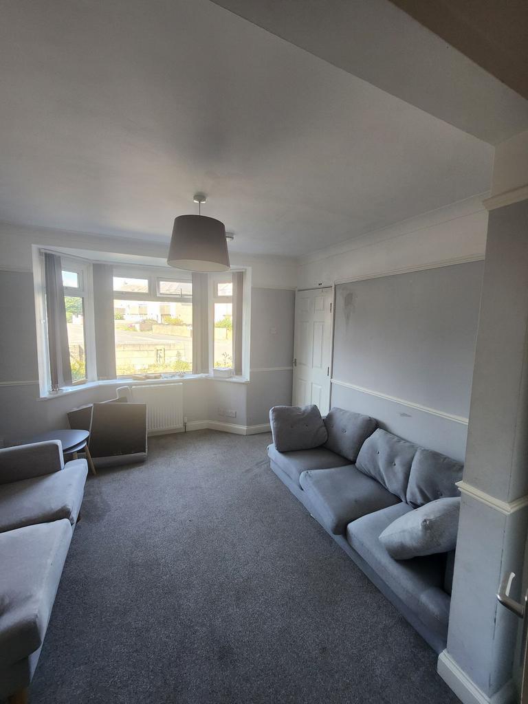 Bright bay-front living room with large windows...