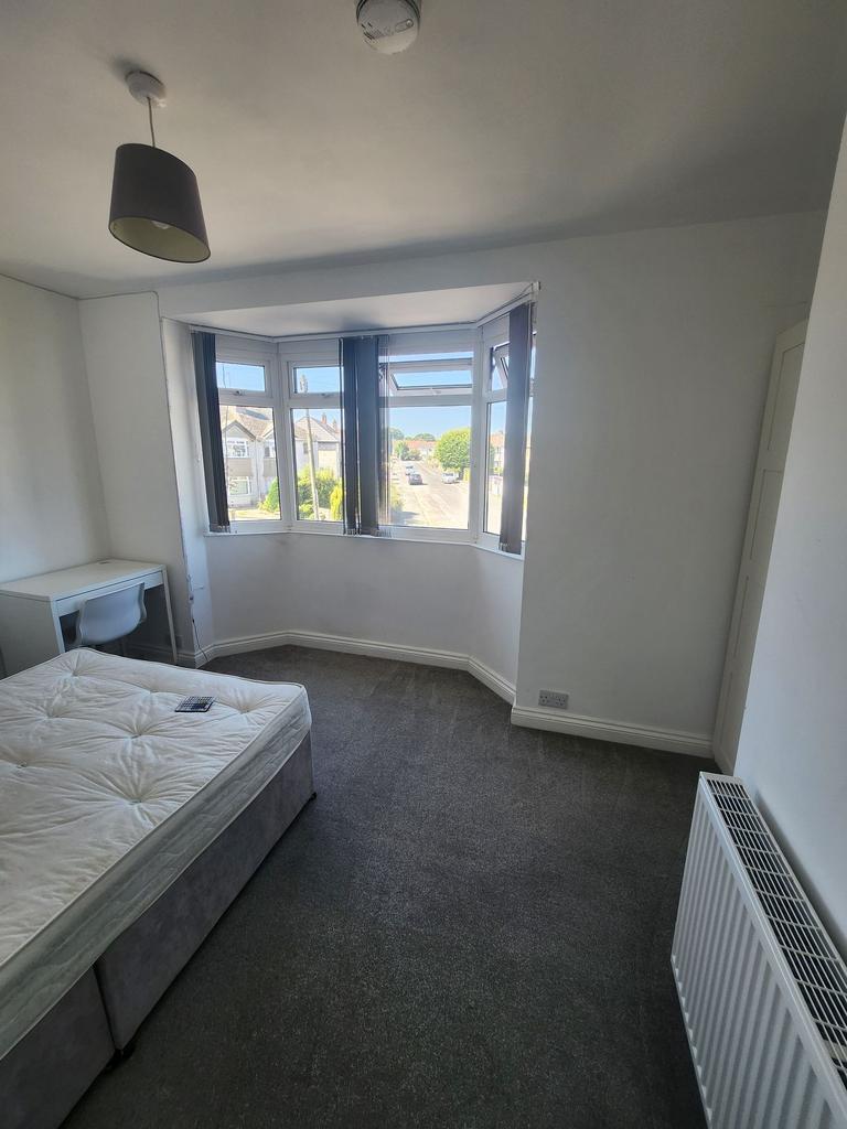 Bright double bedroom with a bay window letting...