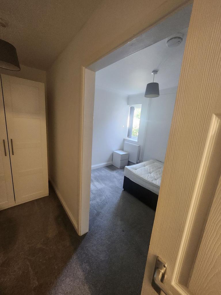 Bright, simply furnished bedroom with neutral c...