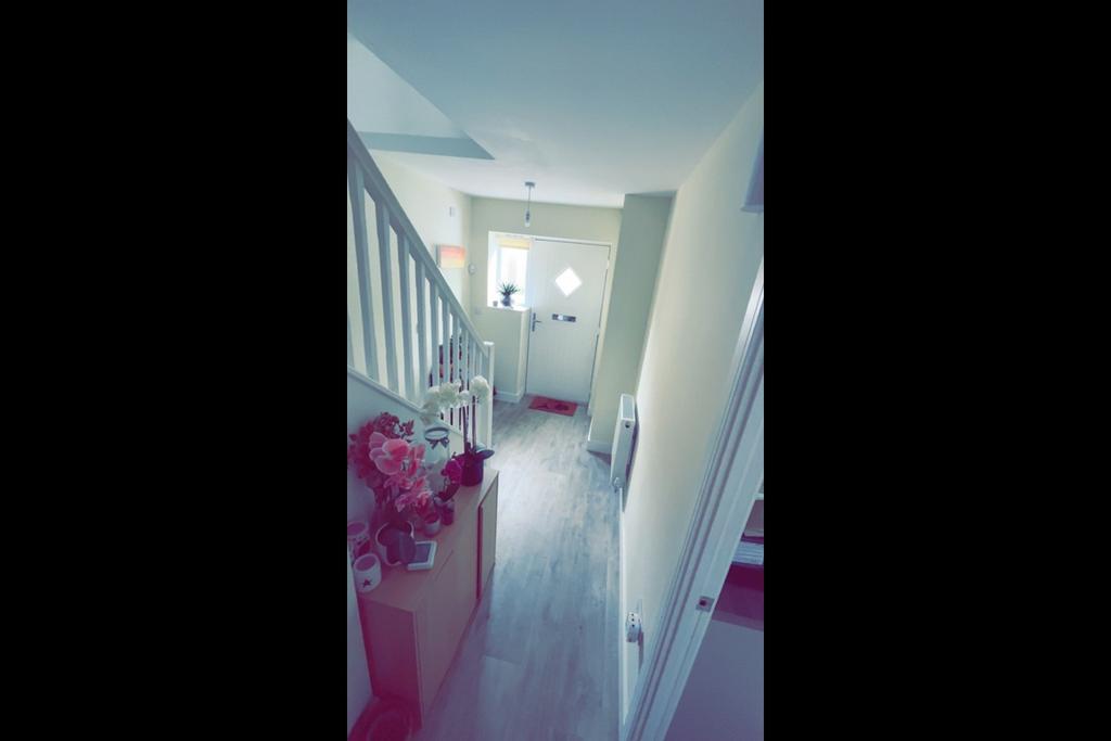 Bright, tidy entrance hallway with pale walls, ...