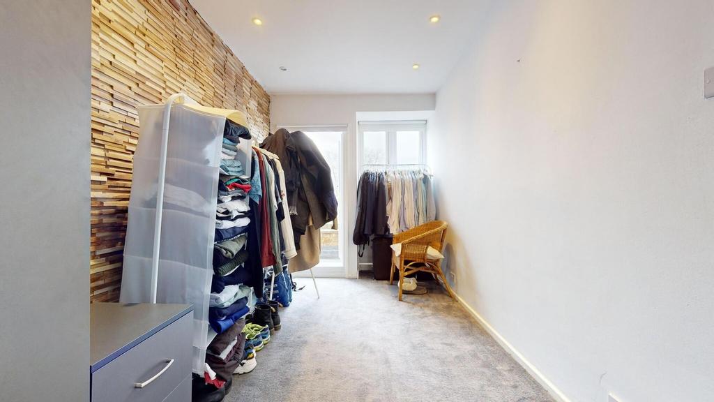 Bright, narrow bedroom with a feature textured ...