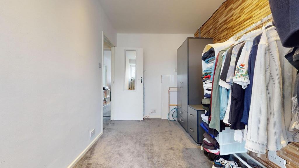 Neat, carpeted single bedroom with built storag...