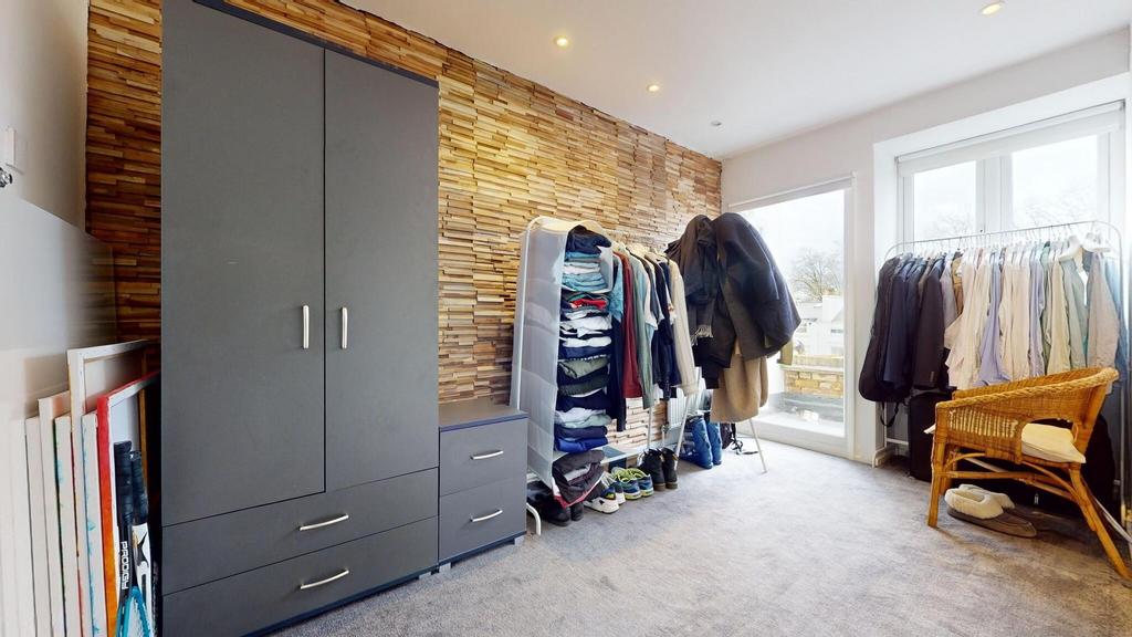 Bright, well-lit bedroom with large windows and...
