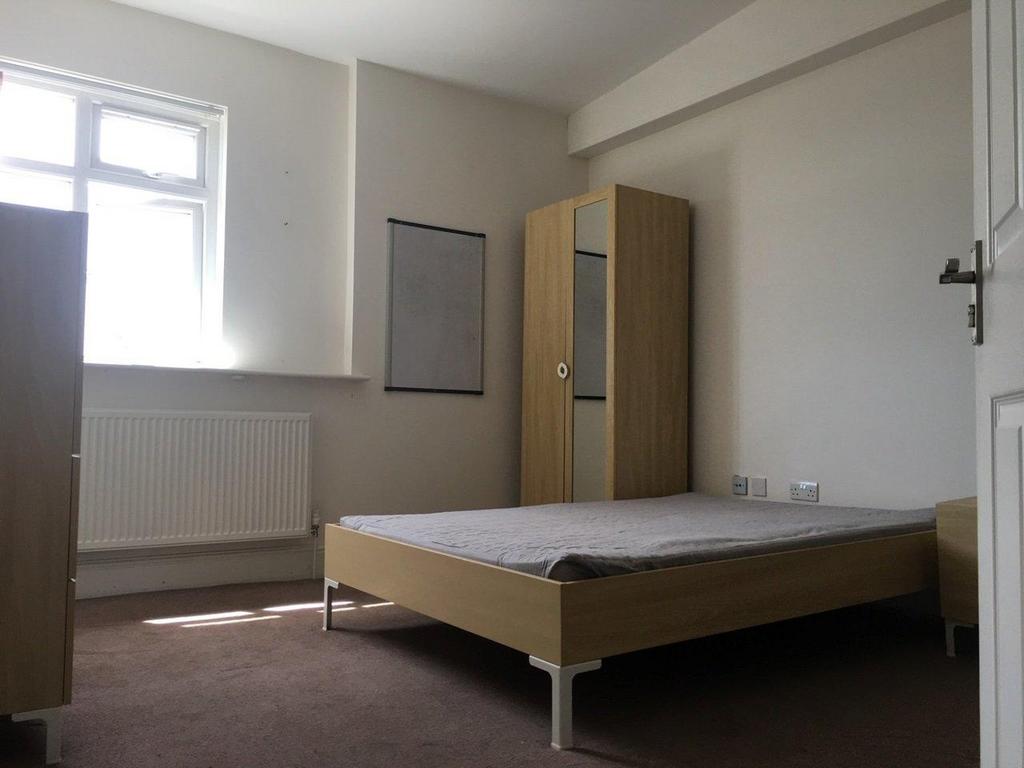 Bright, simply furnished bedroom with a window ...