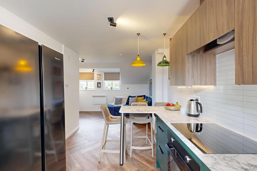 Bright, modern kitchen with wooden cabinetry, i...