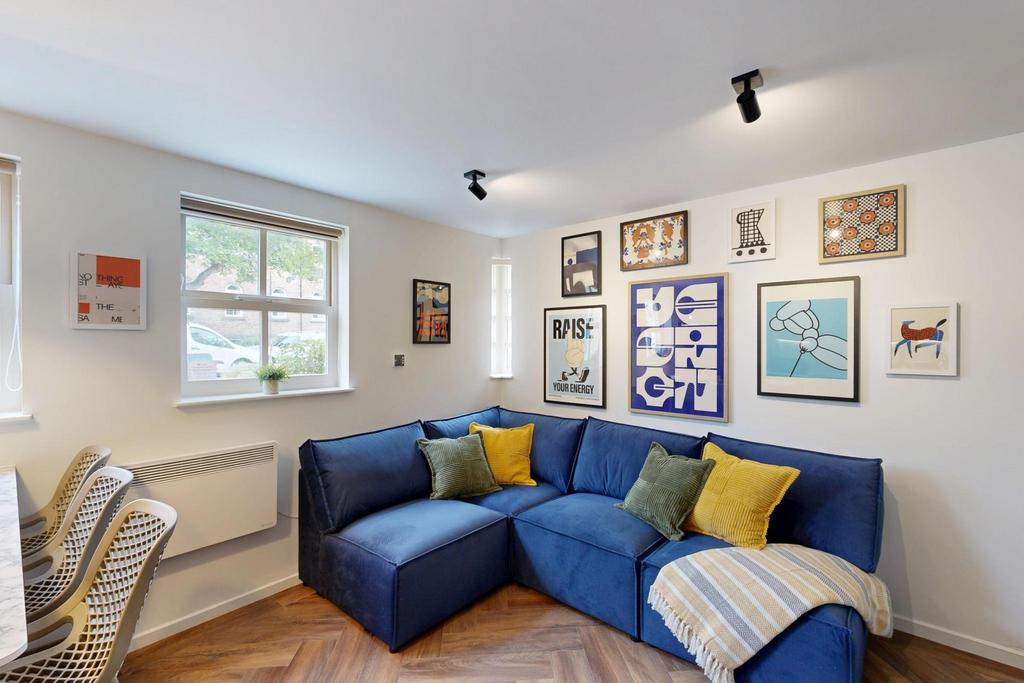 Bright, tastefully styled living room with a co...