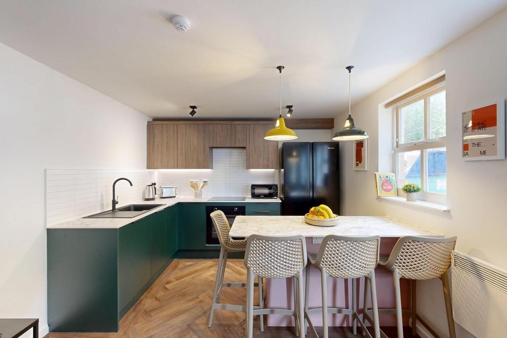 Bright modern kitchen with a breakfast bar, pen...