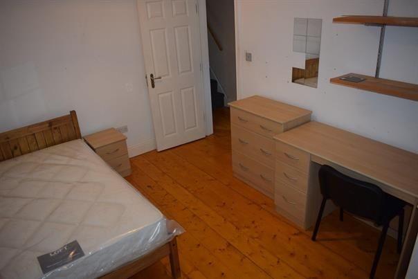Well-kept bedroom with wooden flooring, a doubl...