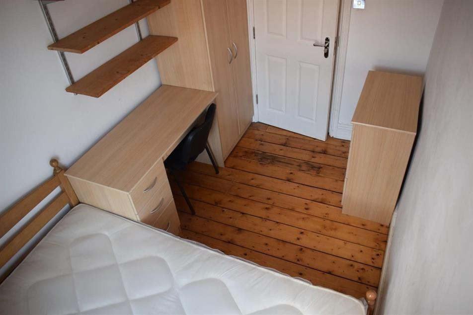Neat single bedroom with wooden floorboards, bu...