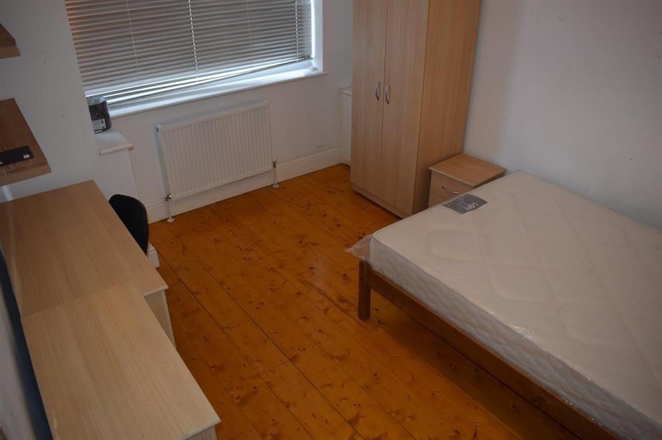 Neat single bedroom with a double bed frame, li...