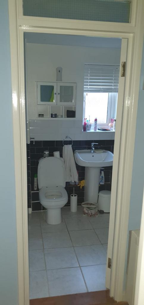 Bright, functional bathroom with a pedestal sin...