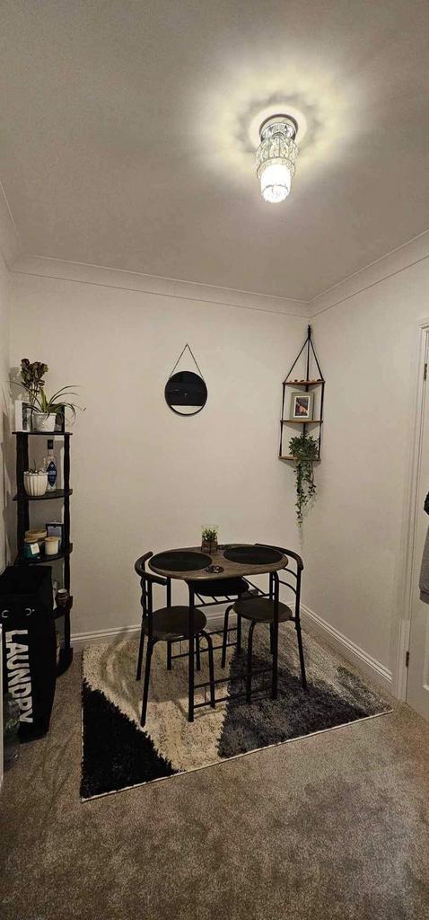 Stylish compact living/dining nook with a round...