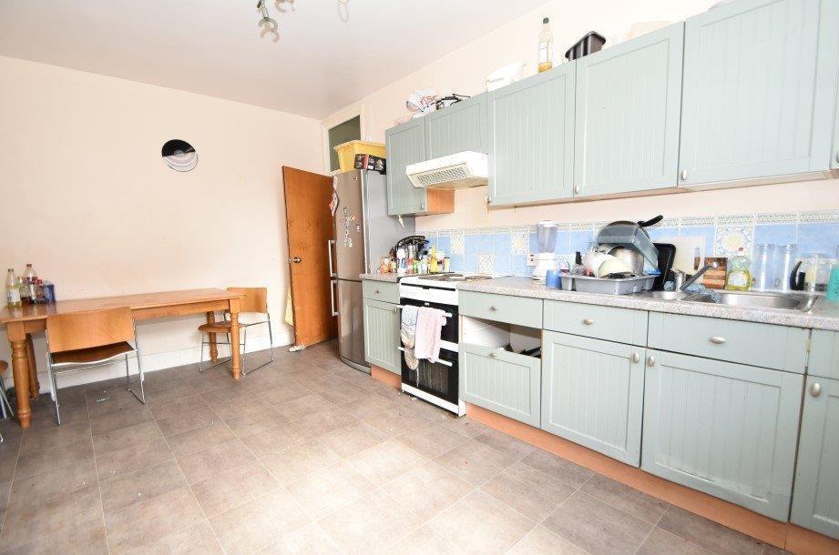 Bright, modern kitchen with ample cabinetry, in...