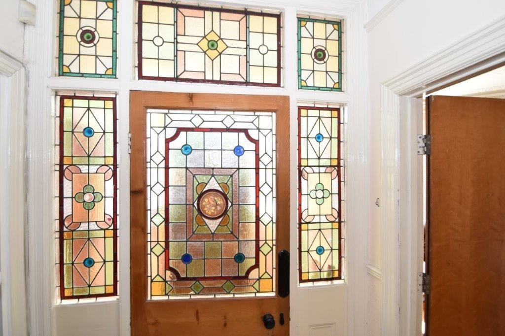 Welcoming entrance with decorative stained-glas...