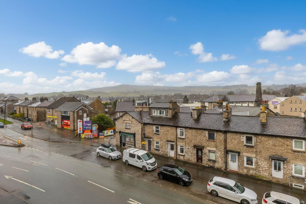Street scene with property, parking
