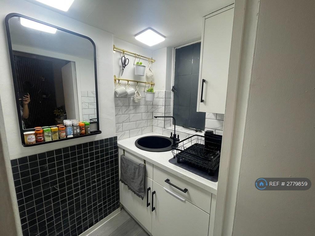 Kitchen With Window, Sink, And Mirror