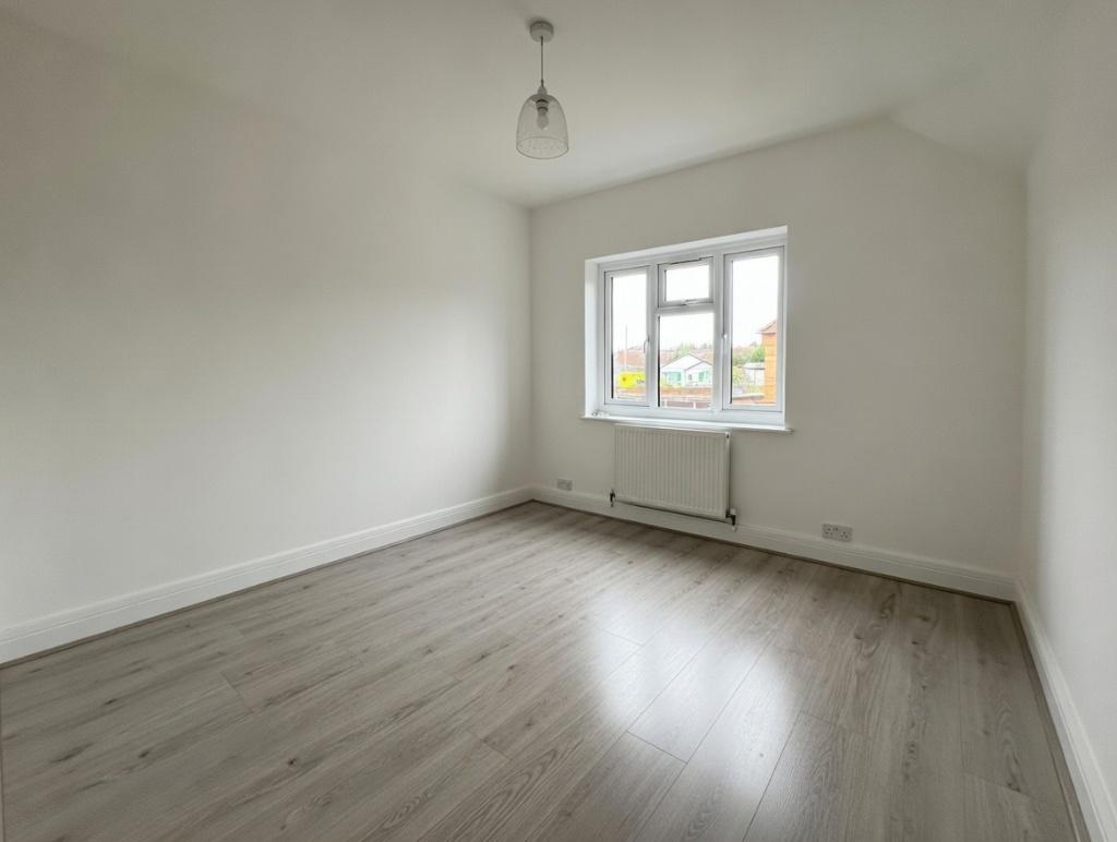 Bright, neutrally decorated bedroom with pale w...