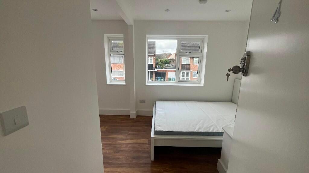 Bright, simply furnished bedroom with a single ...