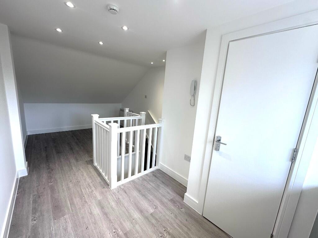 Bright, airy upper landing with modern wood-eff...
