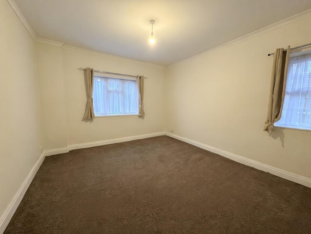 Neutral double bedroom with two windows allowin...
