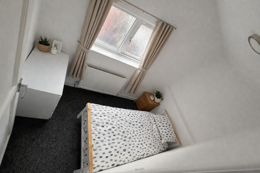 Bright, simply furnished single bedroom with a ...